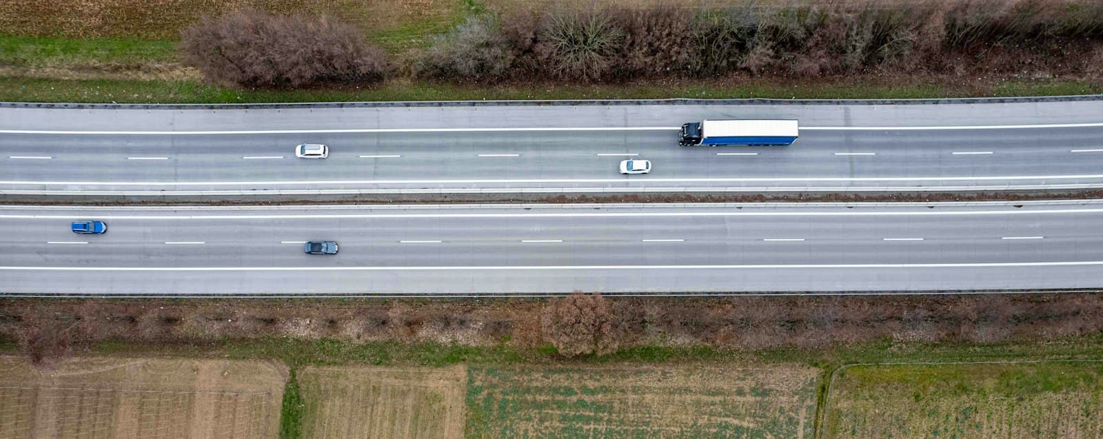 Aerial view of semi trucks on a highway – trucking logistics