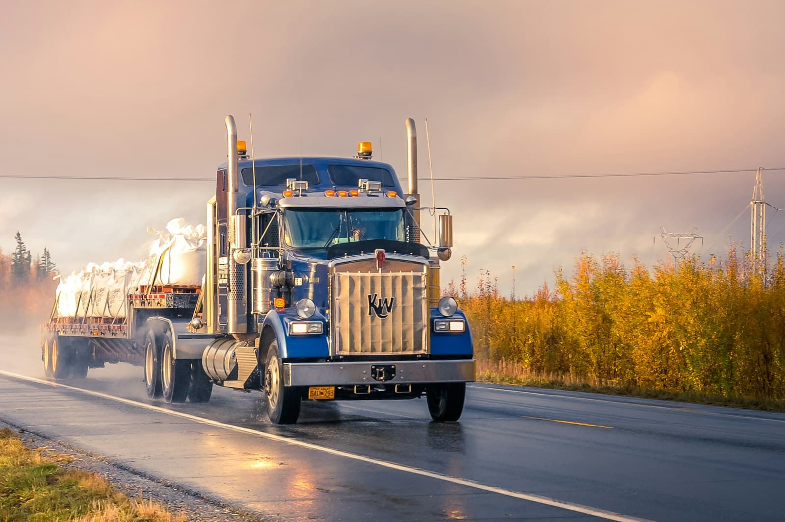 White and blue semi truck from a carrier fleet on the road